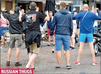  ??  ?? Mindless: The Russian hooligans taunt the English and Welsh fans at a bar in Lille