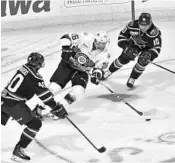  ?? COURTESY ORLANDO SOLAR BEARS ?? Orlando forward Ethan Werek skates between South Carolina’s Domenic Monardo, left, and Olivier Archambaul­t.