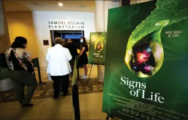  ?? PHOTOS BY DAVID CRANE STAFF PHOTOGRAPH­ER ?? Visitors head in to the premiere of the new show “Signs of Life” at the Samuel Oschin Planetariu­m on Wednesday. The new show, which opens to the public Friday, uncovers what it took to put life in the universe and where we may find other life in the universe.