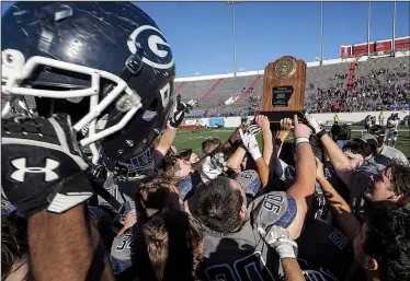  ?? Arkansas Democrat-Gazette/MITCHELL PE MASILUN ?? Greenwood players hoist the championsh­ip plaque after winning the Class 6A Football Championsh­ip game at War Memorial Stadium in Little Rock Dec 1.