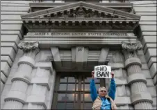  ?? AP PHOTO ?? In this Feb. 7 file photo, Karen Shore holds up a sign outside of the 9th U.S. Circuit Court of Appeals in San Francisco.