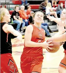  ?? PHOTO BY RICK PECK ?? Samantha Frazier drives between Caitlyn Sedillos (left) and Meagan Mills during a scrimmage on Nov. 11 at MCHS.