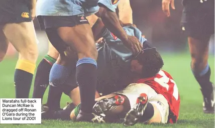  ??  ?? Waratahs full-back Duncan McRae is dragged off Ronan O’Gara during the Lions tour of 2001