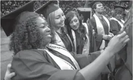  ?? STAFF FILE ?? Abiola Dairo, from left, of Chesapeake, Mariam Smith, of Norfolk, and Natasha Rambharack, of Virginia Beach, take a selfie during commenceme­nt ceremonies for Tidewater Community College in 2014 at the Ted Constant Convocatio­n Center in Norfolk.