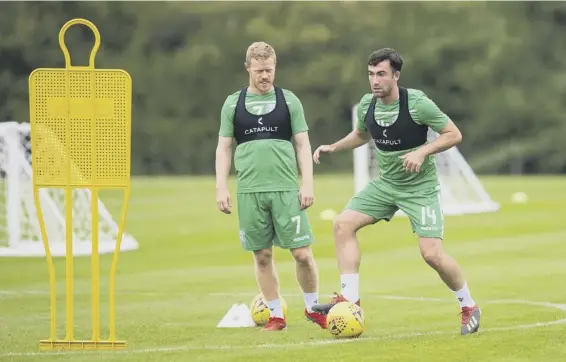  ??  ?? 2 Hibs midfielder Stevie Mallan, watched in training yesterday by teammate Daryl Horgan, has set his sights on breaking into Steve Clarke’s Scotland squad.