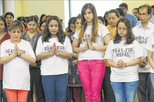  ?? MICHAEL SEARS/MSEARS@JOURNALSEN­TINEL.COM ?? Members of the Hindu Temple of Wisconsin in Pewaukee and the nearby Jain temple say special prayers on Sunday for victims of the April 25 earthquake in Nepal before a brunch that was a fundraiser for those affected by the temblor. For a photo gallery,...