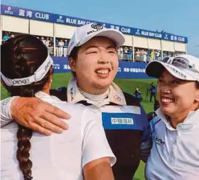  ?? AFP PIC ?? Feng Shanshan (centre) celebrates after winning the Blue Bay LPGA tournament on Saturday.