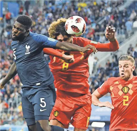  ?? TIM GROOTHUIS/WITTERS SPORT/USA TODAY SPORTS ?? France defender Samuel Umtiti (5) heads the ball in for a goal past Belgium midfielder Marouane Fellaini (8) during the second half in the World Cup semifinals in St. Petersburg, Russia, on Tuesday.