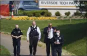  ?? JULIO CORTEZ — THE ASSOCIATED PRESS ?? Police walk near the scene of a shooting at a business park in Frederick, Md., on Tuesday.