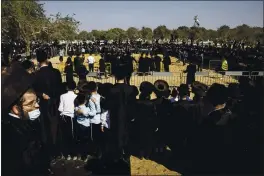  ?? TSAFRIR ABAYOV — THE ASSOCIATED PRESS ?? Large numbers of ultra-Orthodox Jews gather for the funeral for Rabbi Mordechai Leifer, in the port city of Ashdod, Israel, on Monday.