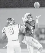  ?? Thomas B. Shea ?? Pearland’s Jaelin Benefield (2) makes a catch against George Ranch defender Brent Ugo (21) during the first half of Friday’s game at the Rig in Pearland.