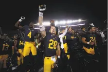  ?? Ezra Shaw / Getty Images ?? Running back Patrick Laird (28) and his teammates celebrate Saturday after beating Mississipp­i at Memorial Stadium.