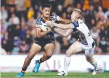  ?? ?? Junior Tupou fends off Tom Dearden. Picture: Getty Images