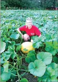  ?? Photo submitted ?? Melissa Bond poses with one of the pumpkins growing in her pumpkin patch in mid-summer.