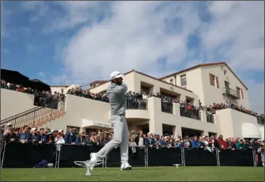  ?? The Associated Press ?? TOP OF THE WORLD: Dustin Johnson tees off on the first hole during the final round of the Genesis Open golf tournament at Riviera Country Club, Sunday in the Pacific Palisades area of Los Angeles. Johnson’s win earned him the top golf ranking in the...