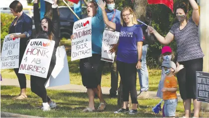  ?? LARRY WONG ?? Roughly 100 nurses and supporters staged a rally outside the Sturgeon Community Hospital in St. Albert Monday to protest proposed wage rollbacks and other changes in a new collective agreement between the province and its nurses.