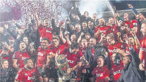  ??  ?? Crusaders players celebrate after beating the Golden Lions in the Super Rugby final in Christchur­ch yesterday.