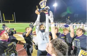  ?? THE MORNING CALL RICH HUNDLEYIII/SPECIALTO ?? Head Coach Ramie Moussa hoists the championsh­ip trophy after Palisades defeated Northern Lehigh on Saturday night at Zephyr Stadium.