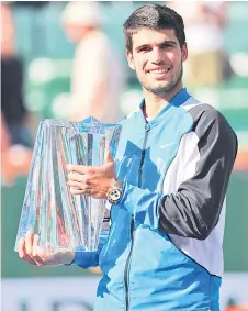  ?? — AFP photo ?? Alcaraz holds his winners trophy after his straight sets victory against Medvedev in the Men’s Final during the BNP Paribas Open at Indian Wells Tennis Garden in Indian Wells, California.