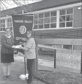  ??  ?? Mary Ann Murphy, secretary at Heroes’ Memorial School, receiving a cheque for $500 from Debbie Johnston of the Yamaska Valley Optimist Club for the school’s breakfast program.