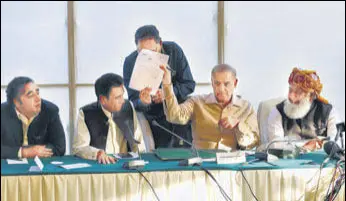  ?? AGENCIES/F ?? (Top) Pakistan’s Prime Minister Imran Khan (centre) along with other lawmakers during a rally; Opposition leader Shehbaz Sharif (second right), along with Bilawal Bhutto Zardari (left) and Maulana Fazalur-rehman (right) and MQM leader Khalid Maqbool Siddiqui (second left), in Islamabad.