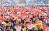  ?? AHN YOUNG-JOON/ASSOCIATED PRESS ?? Protesters hold up cards during a rally for impeached President Park Geun-hye’s arrest in Seoul, South Korea, on Saturday. The signs read “Park Geun-hye’s arrest.”