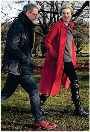  ??  ?? Great outdoors: Theresa and Philip May enjoy a country walk in US Vogue