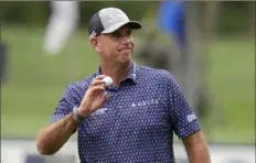  ?? Chris O’Mera/Associated Press ?? Stewart Cink holds up his ball to the gallery after putting out on the fourth hole during the second round of the Valspar Championsh­ip golf tournament Friday at Innisbrook in Palm Harbor, Fla.