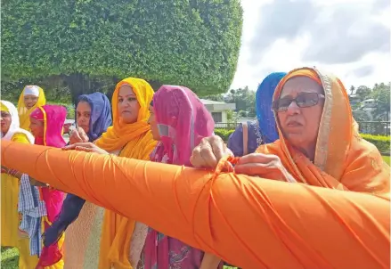  ?? Romeka Kumari ?? Women wrap up pole during the flag raising ceremony for the Baisakhi celebratio­n at the Suva Sikh Temple, in Samabula on April 11, 2024. Photo: