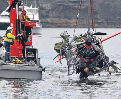  ??  ?? A SEAPLANE that crashed near Sydney killing five Britons has been partially recovered from a river, as it was reported the aircraft had been rebuilt after a previous fatal incident.
The wreckage was lifted out of the Hawkesbury River, five days after...