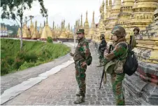  ?? ?? Members of ethnic minority armed group Ta’ang National Liberation Army (TNLA) standing guard in a temple area of a hill camp seized from Myanmar’s military in Namhsan Township in Myanmar’s northern Shan State.