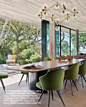  ??  ?? THE OPEN DINING AND LIVING AREA WITH WRAP-AROUND WALL-TOWALL WINDOWS PROVIDE VIEWS THROUGH THE TREES TO THE CITY BOWL BELOW. THE TABLE IS BY OKHA, WITH CHAIRS FROM MINOTTI