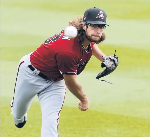  ?? RALPH FRESO/GETTY ?? Diamondbac­ks pitcher Zac Gallen throws prior to a spring training game against the Rockies on Feb. 28 in Scottsdale, Arizona.