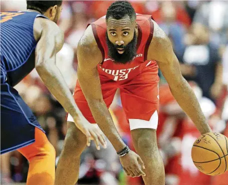  ?? [AP PHOTO] ?? Houston’s James Harden, right, dribbles as Oklahoma City’s Paul George defends during a Christmas Day game in Houston. Harden scored 41 points at the Rockets beat the Thunder, 113-109.