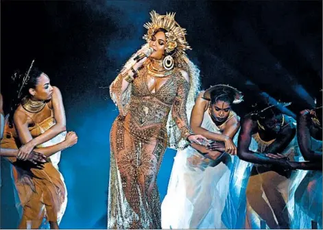  ?? KEVIN WINTER/GETTY ?? Beyonce performs during the 59th Grammy Awards at the Staples Center in Los Angeles on Sunday. The singer was also nominated for multiple awards.