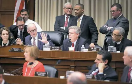  ?? Chip Somodevill­a/Getty Images ?? Rep. Greg Walden, R-Ore, fourth from left, chairman of the House Energy and Commerce Committee, puts up his hands Wednesday while attempting to keep order during a markup hearing on the proposed American Health Care Act, the Republican attempt to...