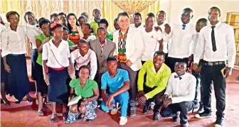  ??  ?? JMCIM Brother Danny Cuarteros poses with Zambians during a recent mission in Ndolo.