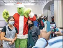  ?? ?? Victoria Medina and Yolanda McNeil get their photo taken with the Grinch.