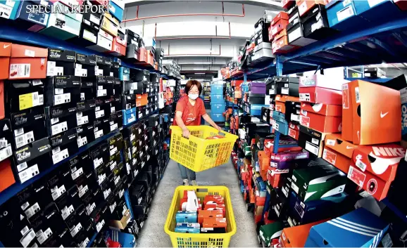  ??  ?? Workers at the Tianma E-commerce Industrial Park, Haizhou District, Lianyungan­g City, Jiangsu Province, are dealing with customers’ orders by collecting the requested items and then preparing them for delivery on May 23, 2020.