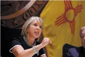  ??  ?? Gov. Michelle Lujan Grisham, at a news conference Tuesday with her Cabinet at the Capitol, said, ‘Everyone’s job in this room is to build that economy. That allows us to do something about deep-rooted poverty.’