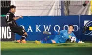  ?? COURTESY OF SWITCHBACK­S FC ?? New Mexico United goalkeeper Cody Mizell lunges to make a save against Switchback­s FC midfielder George Lebese. The teams played to a 1-1 draw.