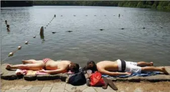  ?? STEVEN SENNE — THE ASSOCIATED PRESS FILE ?? In this May, 26, 2010 file photo, swimmers lie on the edge of Walden Pond in Concord, Mass.