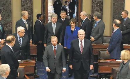  ?? Senate Television photos ?? Sens. Lindsey Graham, RS.C. (left), Patrick Leahy, DVt., Dianne Feinstein, DCalif., and Roy Blunt, RMo., escort Supreme Court Chief Justice John Roberts into the Senate chamber at the Capitol to open the trial and preside over the proceeding­s.