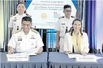  ?? PHOTO BY MARK JOSEPH BARNEDO ?? Philippine Merchant Marine Academy Supt. Commo. Joel Abutal (seated left) and French Ambassador Marie Fontanel during the signing of the MoU for an improved Philippine maritime education and training at the PMMA in Zambales on Friday, Jan. 26, 2024.