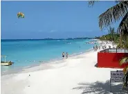 ?? ISTHATITSM­E / BUDGET TRAVEL ?? Jet-skiers and sunbathers enjoy Seven Mile Beach in Negril.