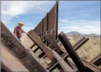  ?? Los Angeles Times/BRIAN VAN DER BURG ?? Gary Thrasher looks over a Normandy vehicle barrier near the San Pedro River bordering his friend and fellow rancher John Ladd’s property in Cochise County, Ariz., earlier this month.