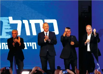  ?? (Ronen Zvulun/Reuters) ?? BLUE AND WHITE Party leader Benny Gantz stands next to Moshe Ya’alon, Yair Lapid and Gaby Ashkenazi in Tel Aviv following the announceme­nt of exit polls on Monday night.