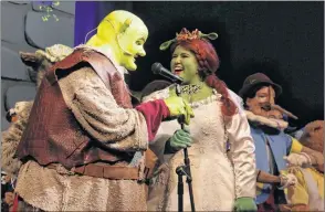  ??  ?? Princess Fiona (Kate Hubley) and Shrek (Steve Roe) share a kiss and Fiona transforms into an ogre. As they prepare to live happily ever after, they perform I’m a Believer.