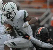  ??  ?? West Bloomfield’s Donovan Edwards, left, breaks the tackle attempt from Belleville’s Tyler Bivens for a touchdown during the fourth quarter of the Lakers’ D1state semifinal victory Saturday.