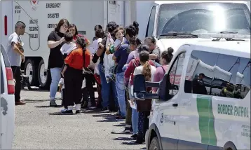  ?? Buy this photo at YumaSun.com FILE PHOTO BY RANDY HOEFT/YUMA SUN ?? A GROUP ARRIVES EARLY IN JUNE AT THE REAR OF WHAT WAS ONCE THE SALVATION ARMY THRIFT STORE, 600 W. Catalina Drive, after being transporte­d to the facility by U.S. Border Patrol personnel aboard USBP vans. The Salvation Army is using the store, which closed in August, as a shelter for migrants crossing into the United States in the Yuma Sector.